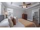 Cozy bedroom featuring a ceiling fan, neutral walls, and two entry ways at 1532 Pineview Sw Ter, Atlanta, GA 30311