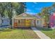 Charming single-story home featuring a welcoming front porch and a neatly manicured lawn at 1532 Pineview Sw Ter, Atlanta, GA 30311