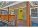 The front porch features natural wood posts and a bright yellow door at 1532 Pineview Sw Ter, Atlanta, GA 30311
