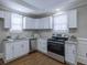 Modern kitchen with white cabinets, stainless steel appliances, and granite countertops at 1532 Pineview Sw Ter, Atlanta, GA 30311