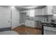 Charming kitchen featuring white cabinets, stainless steel appliances, and a granite countertop at 1532 Pineview Sw Ter, Atlanta, GA 30311