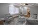 Cozy living room featuring hardwood floors, a ceiling fan, and bright natural light at 1532 Pineview Sw Ter, Atlanta, GA 30311