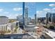 Modern glass high-rise building with rounded corner detail in a city setting against a blue sky at 3324 Peachtree Ne Rd # 1115, Atlanta, GA 30326