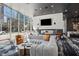 Relax in the luxurious common area with a fireplace, comfortable seating, and floor-to-ceiling windows at 3324 Peachtree Ne Rd # 1115, Atlanta, GA 30326