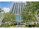 Stunning high-rise exterior with glass facade, surrounded by greenery and a water feature at the entrance at 3324 Peachtree Ne Rd # 1115, Atlanta, GA 30326