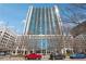 Exterior shot of condo building with high rise and luxury car parked in front at 3324 Peachtree Ne Rd # 1115, Atlanta, GA 30326