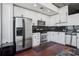 Modern kitchen boasts stainless steel appliances, white cabinets, and black subway tile backsplash at 3324 Peachtree Ne Rd # 1115, Atlanta, GA 30326