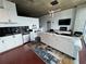 Living room with modern lighting, concrete ceilings, black backsplash, and stainless steel appliances at 3324 Peachtree Ne Rd # 1115, Atlanta, GA 30326