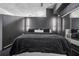 Sleek bedroom with black bedding, modern lighting, and mirrored closet, offering a minimalist retreat at 3324 Peachtree Ne Rd # 1115, Atlanta, GA 30326