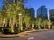 Charming trees adorned with decorative lighting along a sidewalk, adding nighttime curb appeal to buildings beyond at 3324 Peachtree Ne Rd # 1115, Atlanta, GA 30326