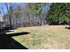 Large backyard featuring shade trees and well-maintained lawn at 67 Mossy Oak Ln, Dallas, GA 30157
