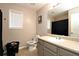 Well-lit bathroom featuring a toilet, single sink vanity and privacy window at 67 Mossy Oak Ln, Dallas, GA 30157
