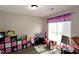 Bright bedroom with neutral walls, plank floors, and a sunlit window at 67 Mossy Oak Ln, Dallas, GA 30157