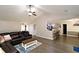 Open floor plan, living room with leather sofa and view into the kitchen at 67 Mossy Oak Ln, Dallas, GA 30157