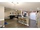 Open floor plan with vaulted ceilings, living room and kitchen with breakfast bar at 67 Mossy Oak Ln, Dallas, GA 30157