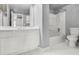 Clean, bright bathroom with double vanity, tiled floor, and shower over tub at 795 Hammond Dr # 1405, Atlanta, GA 30328
