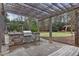 Outdoor grilling area with built-in grill, stone accents, and dining space at 795 Hammond Dr # 1405, Atlanta, GA 30328