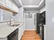 A well-lit kitchenette featuring modern appliances and fixtures at 795 Hammond Dr # 1405, Atlanta, GA 30328