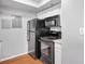 A well-lit kitchenette with a stove, microwave, refrigerator, and white cabinets at 795 Hammond Dr # 1405, Atlanta, GA 30328