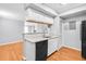 Efficient kitchen with modern fixtures, white cabinetry, breakfast bar and stainless steel appliances at 795 Hammond Dr # 1405, Atlanta, GA 30328