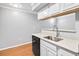 Well-lit kitchen featuring a stainless steel sink, dishwasher, white cabinets, and hardwood flooring at 795 Hammond Dr # 1405, Atlanta, GA 30328