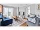 Cozy living room with modern furniture, balcony access, and hardwood flooring at 795 Hammond Dr # 1405, Atlanta, GA 30328