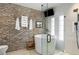 Bathroom showcases a contemporary standalone tub within a glass shower, complemented by a brick accent wall at 1354 Fernwood Ne Cir, Brookhaven, GA 30319
