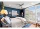 Bedroom with large windows that provide natural light, complemented by dark blue walls and hardwood floors at 1354 Fernwood Ne Cir, Brookhaven, GA 30319