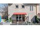 View of the building exterior featuring a red awning and second story balcony at 1354 Fernwood Ne Cir, Brookhaven, GA 30319