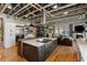Spacious open-concept kitchen features a large center island, stainless steel appliances, and exposed ceiling beams at 1354 Fernwood Ne Cir, Brookhaven, GA 30319