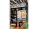 Living room with bookshelves, leather chairs, bar area, exposed ceiling beams, and pendant lights at 1354 Fernwood Ne Cir, Brookhaven, GA 30319