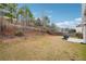 Expansive backyard with mature trees, a privacy fence and a cozy patio seating area at 5932 Vinings Vintage Way, Mableton, GA 30126