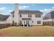 A spacious backyard with grass and a patio area at 5932 Vinings Vintage Way, Mableton, GA 30126