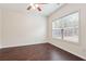 Bright bedroom with a large window, ceiling fan, and hardwood floors at 5932 Vinings Vintage Way, Mableton, GA 30126