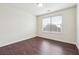 Bedroom with wood floor and large window with blinds at 5932 Vinings Vintage Way, Mableton, GA 30126