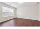 Bright bedroom with wood-look flooring and large window offering plenty of natural light at 5932 Vinings Vintage Way, Mableton, GA 30126