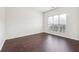 Bright bedroom featuring rich dark hardwood floors, and large window with views of the property at 5932 Vinings Vintage Way, Mableton, GA 30126
