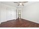 Bedroom with hardwood floors, a ceiling fan, and a closet with double doors at 5932 Vinings Vintage Way, Mableton, GA 30126