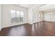 Bright dining room featuring rich dark hardwood floors, white walls, and modern chandelier at 5932 Vinings Vintage Way, Mableton, GA 30126
