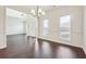 Bright dining room featuring rich dark hardwood floors, white walls, and modern chandelier at 5932 Vinings Vintage Way, Mableton, GA 30126