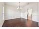 Bright dining room featuring rich dark hardwood floors, white walls, and modern chandelier at 5932 Vinings Vintage Way, Mableton, GA 30126