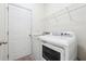 Laundry room featuring a white washer and dryer and a wire shelf at 5932 Vinings Vintage Way, Mableton, GA 30126
