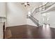 Spacious living room featuring rich dark hardwood floors, high ceilings, fireplace, and staircase at 5932 Vinings Vintage Way, Mableton, GA 30126