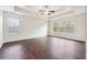 Spacious main bedroom with tray ceiling, fan, and large windows offering natural light at 5932 Vinings Vintage Way, Mableton, GA 30126