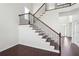 Elegant staircase with dark wood treads, white risers and decorative wrought iron railing at 5932 Vinings Vintage Way, Mableton, GA 30126