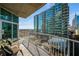 A charming balcony with seating and views of a modern building and the city at 943 Peachtree Ne St # 1108, Atlanta, GA 30309