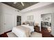 Bedroom featuring a comfortable bed, hardwood floors, and open access to the adjacent living area at 943 Peachtree Ne St # 1108, Atlanta, GA 30309