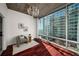 Sun-filled bedroom with large windows showcasing city views, complemented by a chic chandelier at 943 Peachtree Ne St # 1108, Atlanta, GA 30309