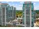 Modern condo complex featuring floor-to-ceiling windows, a central pool and sundeck, and lush landscaping at 943 Peachtree Ne St # 1108, Atlanta, GA 30309