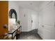 Apartment hallway with white walls, black marble floors, a mirror, and a console table at 943 Peachtree Ne St # 1108, Atlanta, GA 30309